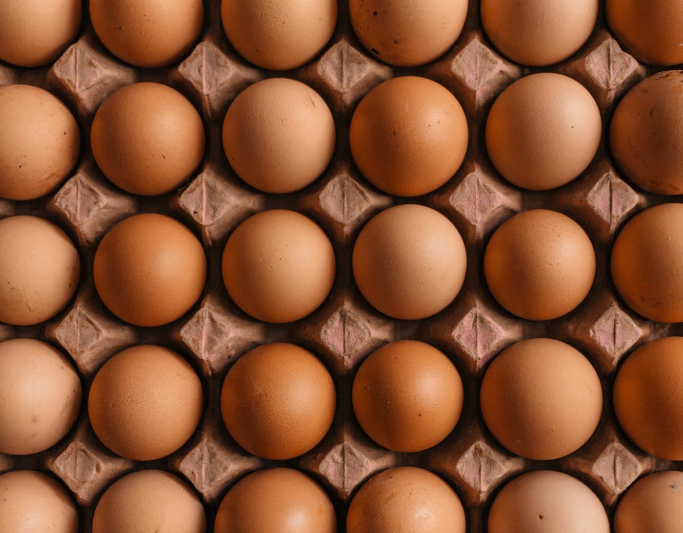 Brown eggs arranged in a moulded cardboard carton